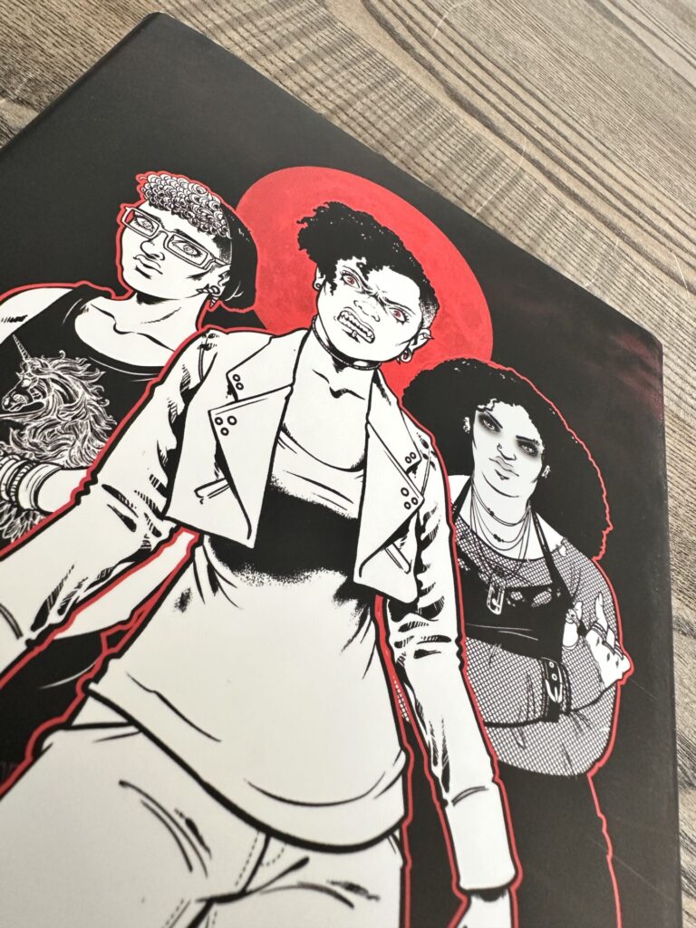 Monsterhearts 2 cover close-up. It depicts three monstrous, insecure teenagers under a blood red moon in black, white, and red.